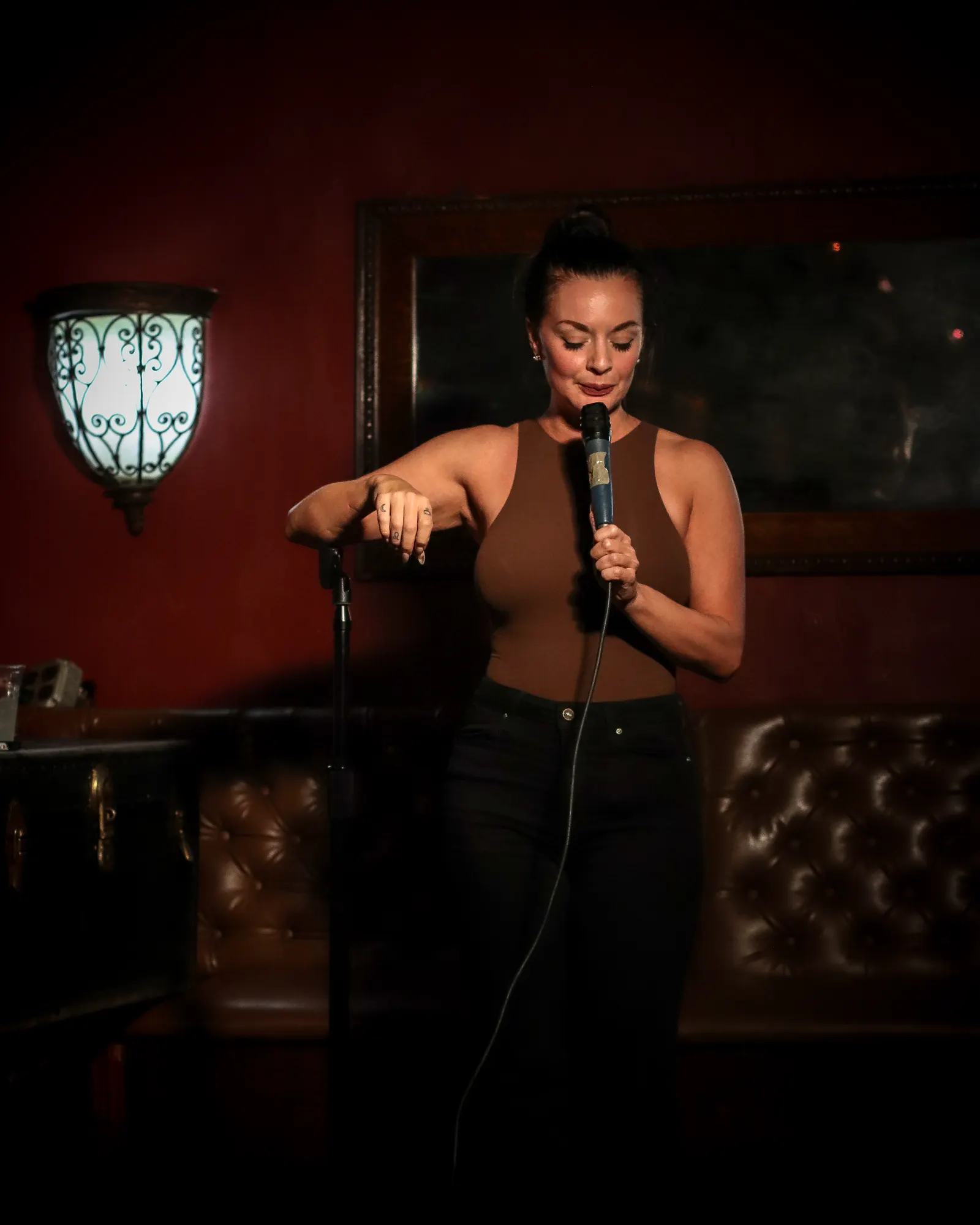 Comedian at the mic stand on stage at Upper East Side Comedy Club