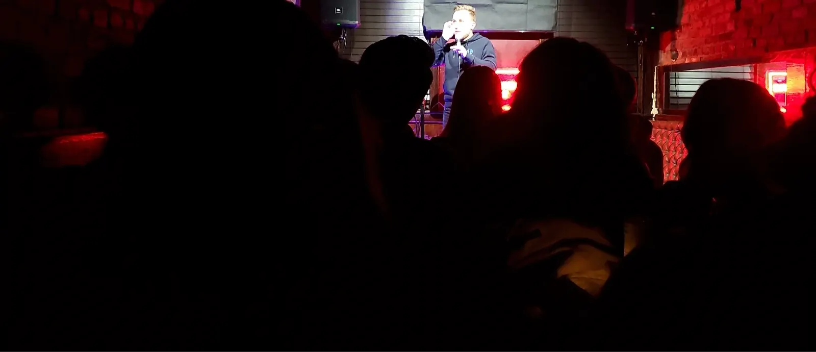Dimly lit comedy room during a live set at Upper East Side Comedy Club